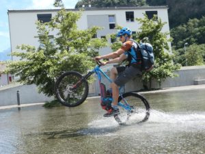 Mountainbiker fährt Wheelie beim Fahrtechnik-Kurs mit dem E-MTB